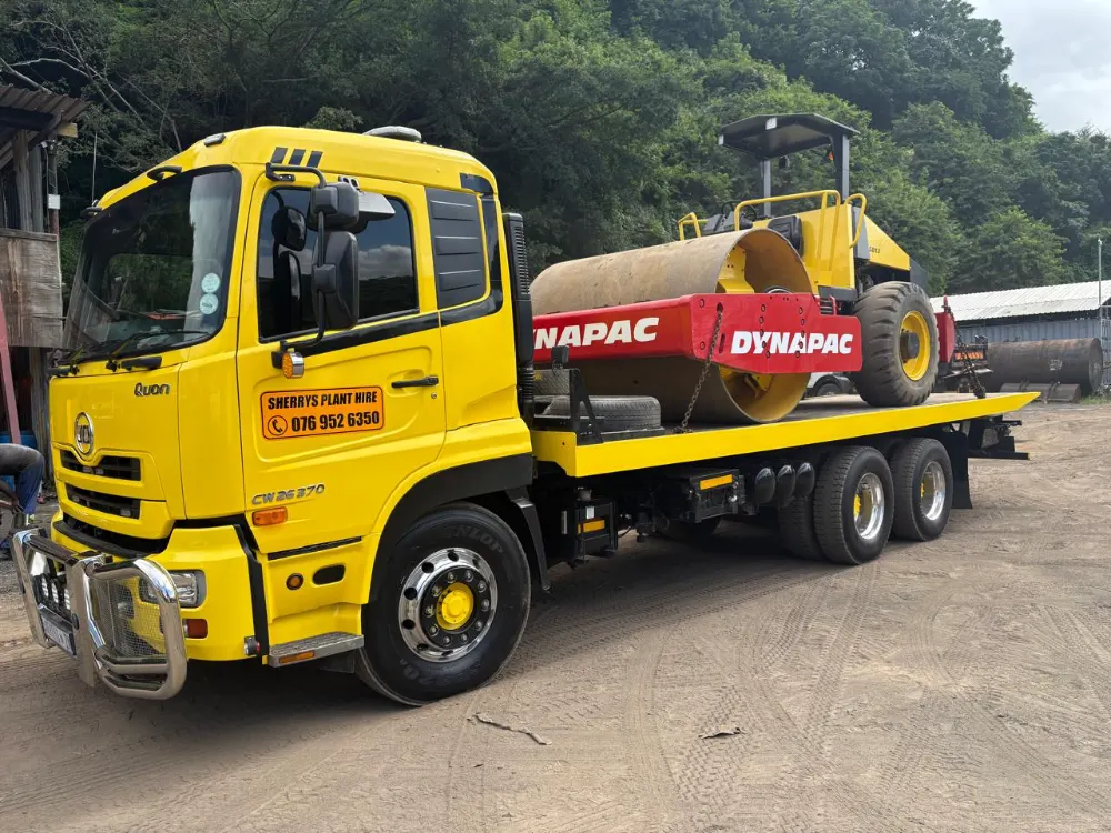 Sherry's rollback loaded with a Dynapac smooth drum roller, chained down for the road