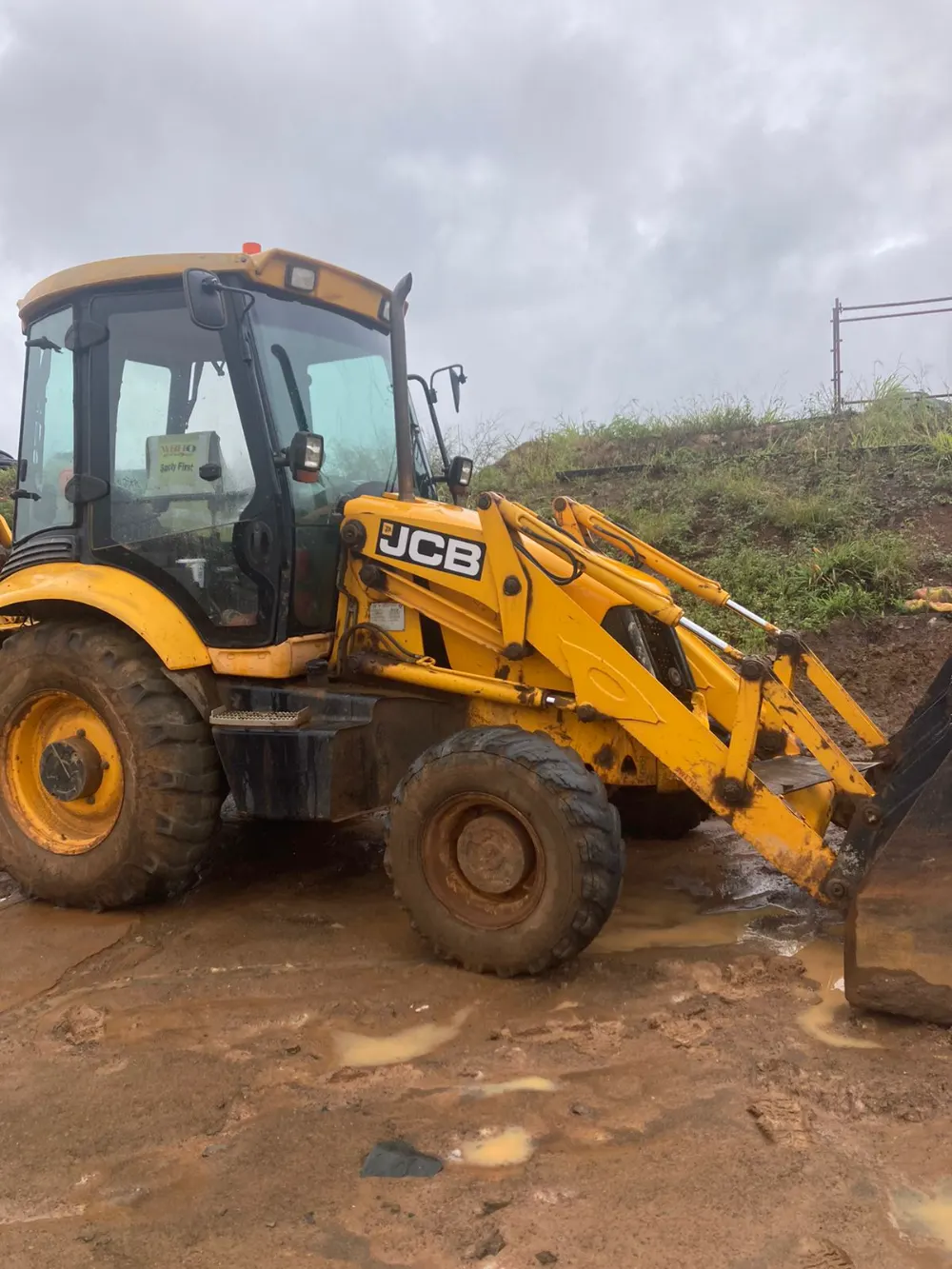 Sherry's JCB TLB standing in wet ground after Durban rain
