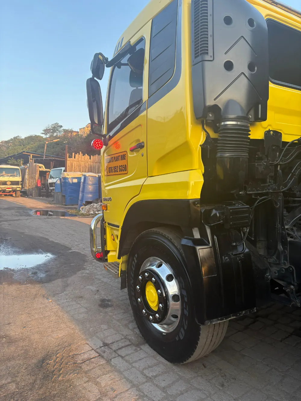 The signwritten cab of one of Sherry's yellow UD rollback trucks